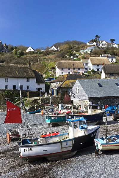 Fishing boats pulled onshore in the pretty Cornish fishing village of Cadgwith, Cornwall