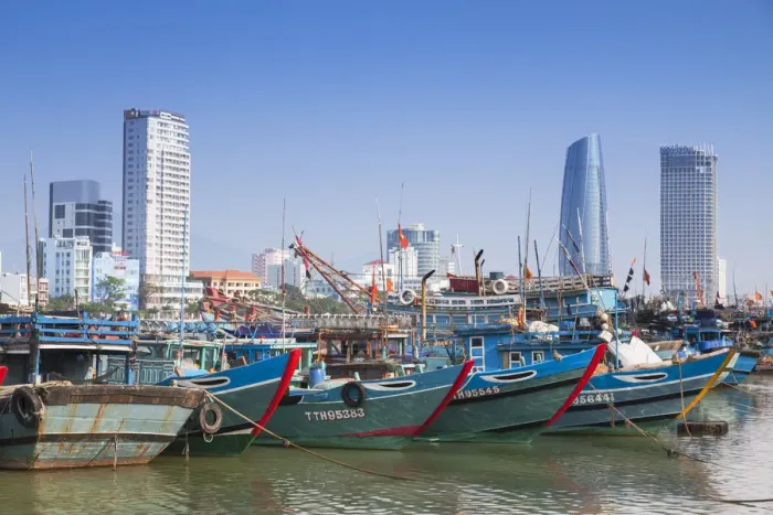Framed Print : Fishing boats on Song River and city skyline, Da Nang, Vietnam Framed Print : Fishing boats on Song River and city skyline, Da Nang, Vietnam