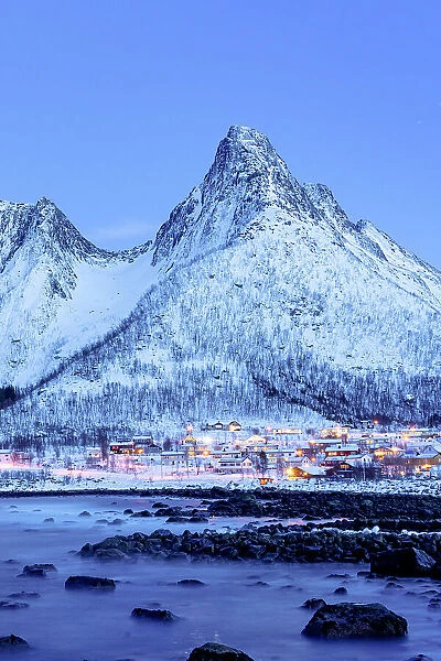 Fishing village of Mefjordvaer and snowy mountains at dusk, Senja, Troms county, Norway