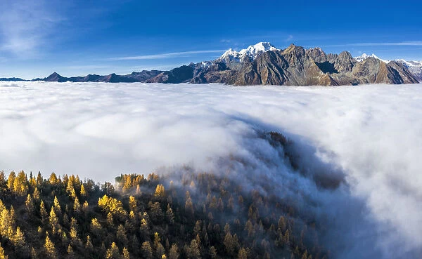 Fog covers the Valmalenco(Val Malenco) with the mountain range of Disgrazia in the