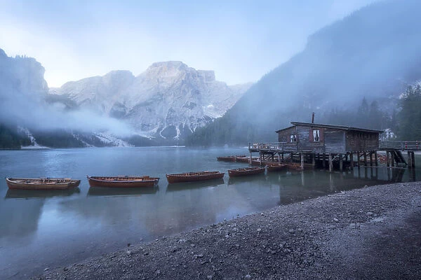 A foggy late summer morning at the famous Braies lake, as the clouds were lifting and the mountains starting to reveal themselves. Dolomites, Italy