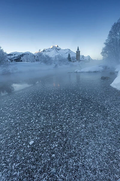 Foggy sunrise in winter. Sils Maria, Sils im Engadin, Graubunden, Switzerland