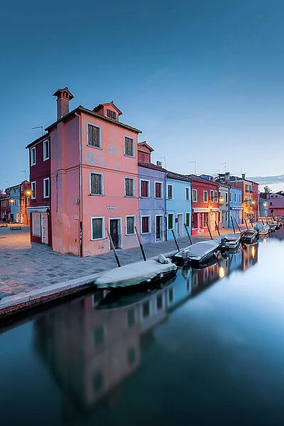 Fondamenta Cavanella with its boats and its colorful buildings before the dawn, Burano island, Venice, Veneto, Italy