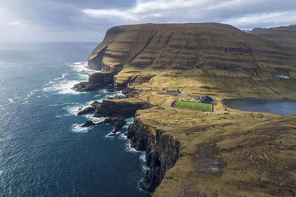 Football field in Vagur close to the cliffs on the west coast of Suðuroy. Faroe Islands