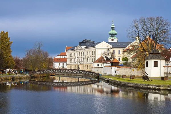 Footbridge over the Blind Shoulder of the Malse river named Muselak and tower of Dominican Monastery, Ceske Budejovice, South Bohemian Region, Czech Republic