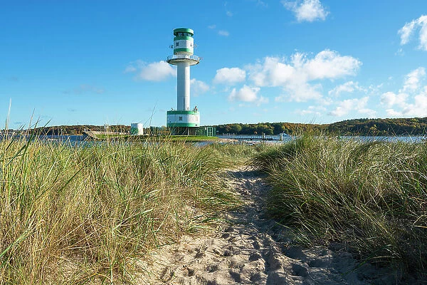 Footpath amidst grass against Friedrichsort lighthouse, Kiel, Schleswig-Holstein, Germany