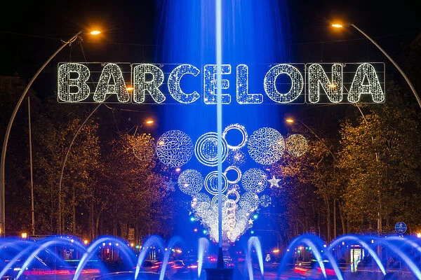 Fountain and Christmas lights in Gran Via avenue, Barcelona, Catalonia, Spain