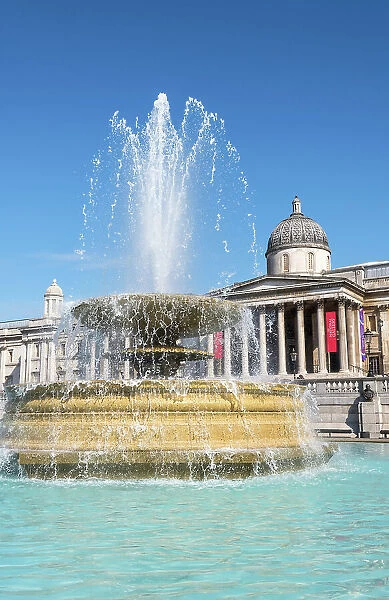 A fountain designed by Sir Edwin Lutyens, with The National Gallery in the background, Trafalgar Square, London England