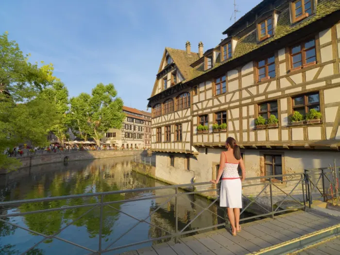 Framed Print : France, Alsace, Strasbourg, La-Petie-France, Woman looking at view (MR) Framed Print : France, Alsace, Strasbourg, La-Petie-France, Woman looking at view (MR)