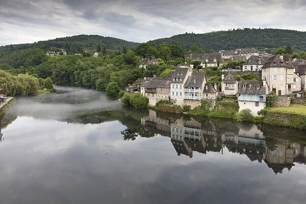 France, Correze, Argentat, The old town reflected in the Dordogne river with some