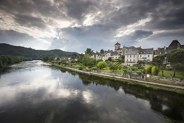 France, Correze, Argentat, The old town and riverbank reflected in the Dordogne river