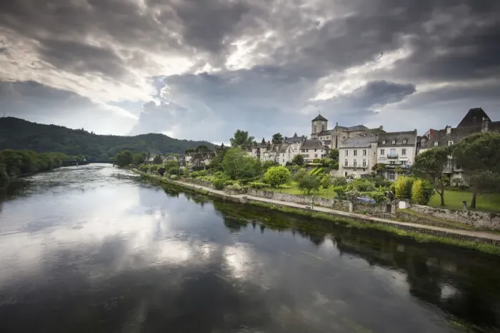 Framed Print : France, Correze, Argentat, The old town and riverbank reflected in the Dordogne river
