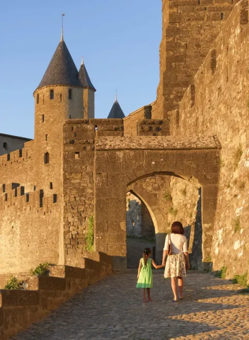 Framed Print : France, Languedoc, Carcassonne, Woman and girl walking to Aude gate (MR)