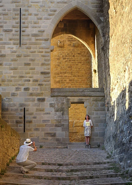 France, Languedoc, Carcassonne, Man photographing woman (MR)