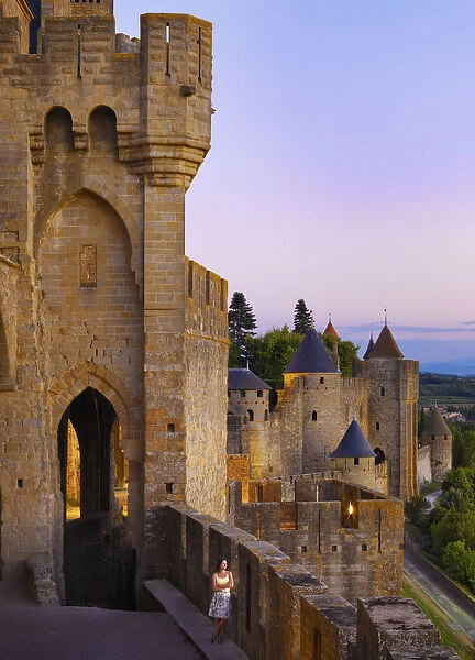 France, Languedoc, Carcassonne, Woman looking at view from walls at dusk (MR)