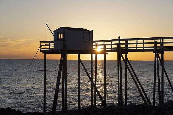 France, Nouvelle-Aquitaine, Charente Maritime, Saint-Palais-sur-Mer, a stilt fishing hut (carrelet) at sunset