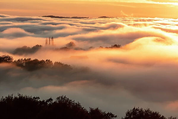 France, Nouvelle-Aquitaine, Correze, landscape at the edge of the fog at sunset