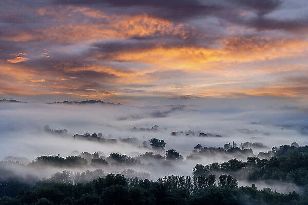 France, Nouvelle-Aquitaine, Correze, Curemonte, a misty valley at sunset near Curemonte