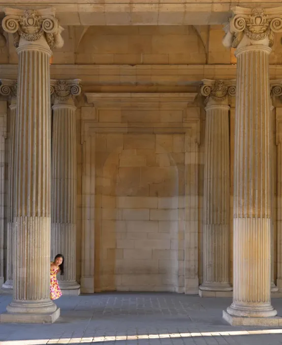 Framed Print : France, Paris, The Louvre, girl aged 8 hiding behind pillar (MR)