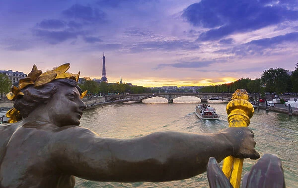 France, Paris, Pont Alexandre III with Eiffel Tower in background at dusk