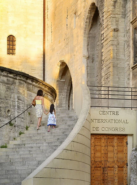 France, Provence, Avignon, Palais de Papes, Woman and girl walking up stairway MR