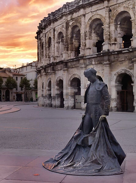 France, Provence, Nimes, Roman ampitheatre, Toreador statue at sunset