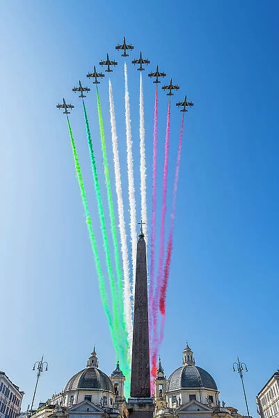 The Frecce Tricolori aerobatic team flying over Piazza del Popolo with smoke trails representing the national colours of Italy during the celebrations of Italian National Day in Rome, Lazio, Italy
