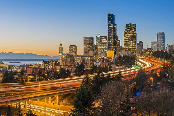 Freeway traffic and downtown skyline at dusk, Seattle, Washington, USA
