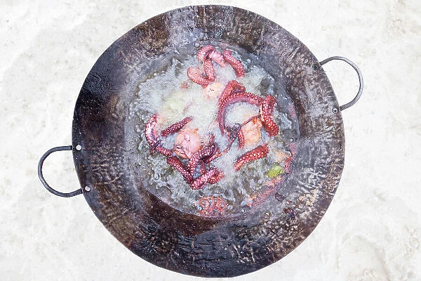 a freshly caught octopus is cooked on the beach, Zanzibar, Tanzania