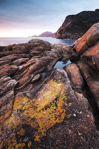 Freycinet National Park, Tasmania, Australia. Sunrise over rocky coast