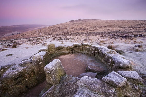 Frost coats a hut circle dwelling in the bronze age settlement of Grimspound in Dartmoor