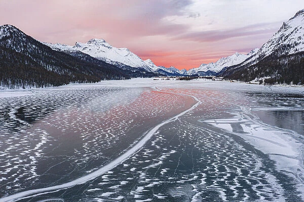 Frozen Lake Silvaplana at sunrise during the cold winter, Maloja, Engadine