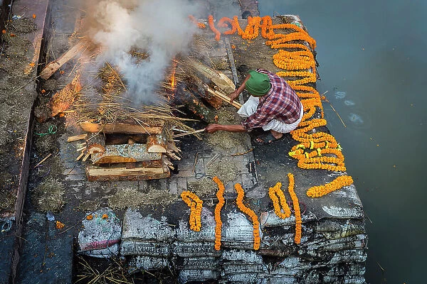Funeral pyre at the cremation ghats on the Bagmati River, Pashupatinath, Kathmandu, Nepal
