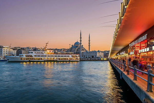 Galata bridge and New Mosque (Yeni Camii) at sunset, Istanbul, Turkey