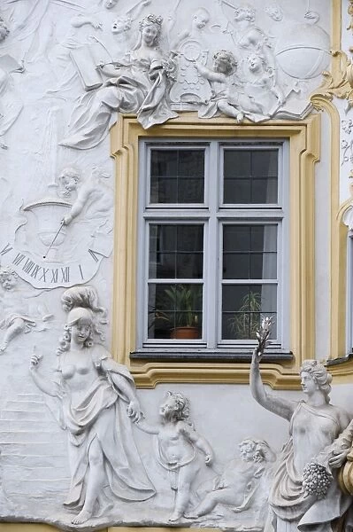 Germany, Bavaria, Munich. Ornate stucco or plasterwork adorning the front of a house in the city