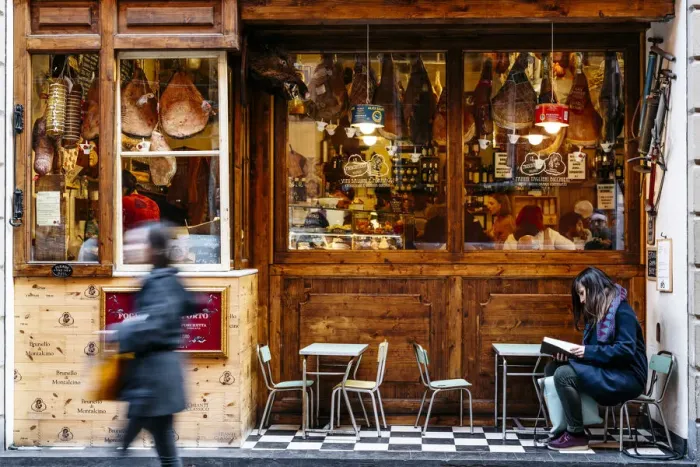 Framed Print : Girl reading in front of a traditional Salumeria in Bologna, Emilia Romagna, Italy Framed Print : Girl reading in front of a traditional Salumeria in Bologna, Emilia Romagna, Italy
