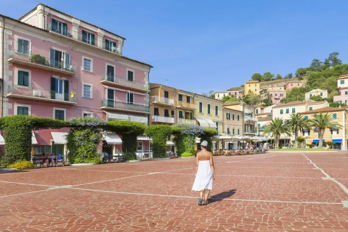 Framed Print : A Girl is walking in the square of Porto Azzurro (Elba Island, Livorno, Tuscany