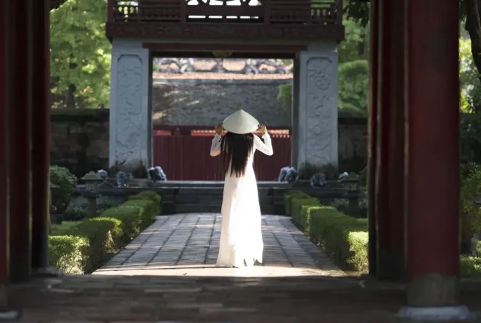 Framed Print : Girl wearing Ao Dai dress and Non La conical hat, Temple of Literature, Hanoi, Vietnam Framed Print : Girl wearing Ao Dai dress and Non La conical hat, Temple of Literature, Hanoi, Vietnam