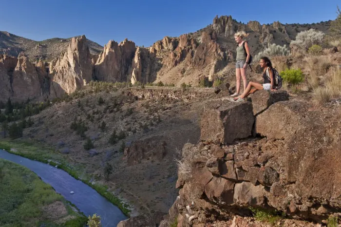 Framed Print : Two girls resting on cliff face, Smith Rock State Park, Central Oregon, USA MR