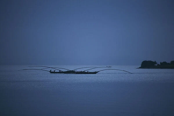 Gisenyi, Rwanda. Night fishermen head out onto lake Kivu with specially adapted boats