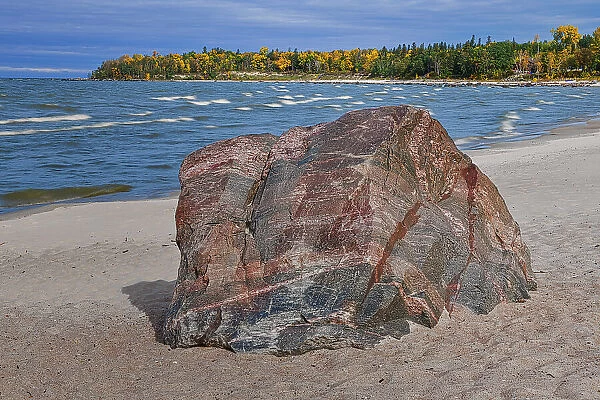 Glacial erratic on snady shore of Lake Winnipeg Victoria Beach Provincial Park, Manitoba, Canada