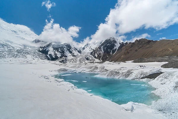 Glacier lake at the base of Peak Lenin mount during early summer