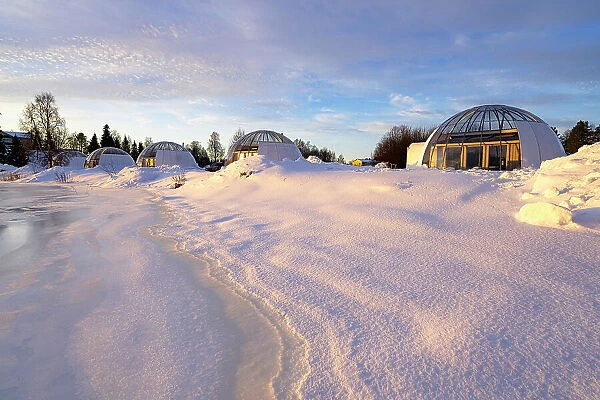 Glass igloo of a luxury tourist resort covered with snow on the banks of a frozen river, Ice and Light village, Kalix, Norrbotten county, Lapland, Sweden