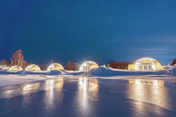 Glass igloo on the snowy shores of the frozen river Kalix, Ice and Light village, Kalix, Norrbotten county, Lapland, Sweden