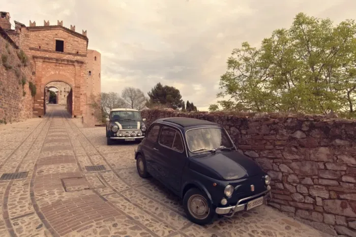 Framed Print : Glimpse of Spello with vintage cars in the foreground, Spello, Perugia district, Umbria