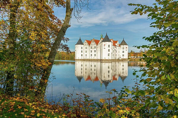 Glucksburg castle in autumn with reflection on Schlossteich, Glucksburg, Schleswig-Flensburg, Schleswig-Holstein, Germany