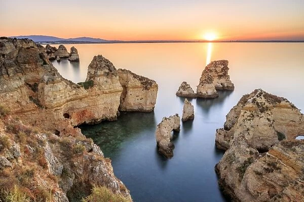 Golden sunrise on the red cliffs of Ponta da Piedade Lagos Algarve Portugal Europe