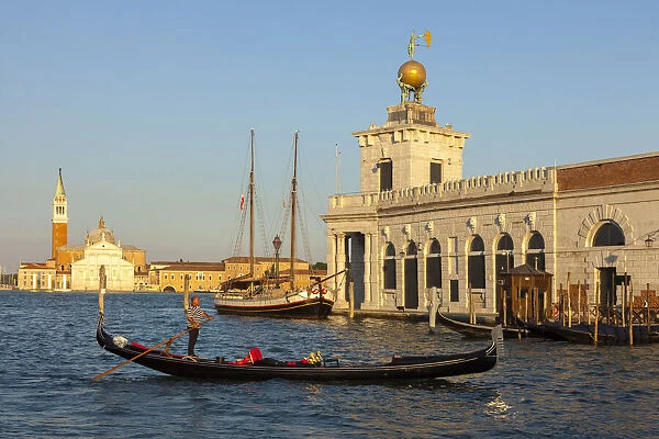 Gondola in front of the Dogana da Mar, behind the Isola di San Giorgio with San Giorgio Maggiore; Venice, Veneto; Italy; Europe