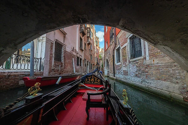 A gondola ride in Venice, navigating through the small canals of the city centre. Venice, Italy
