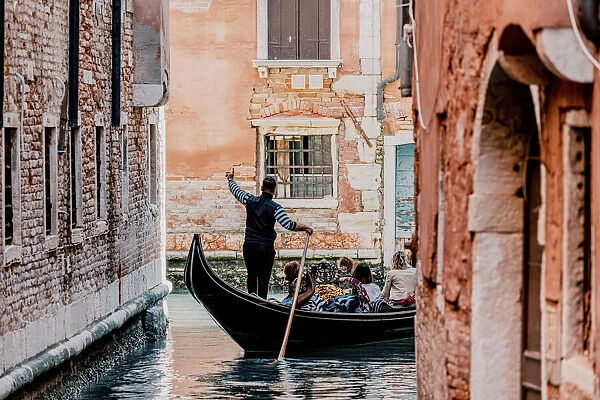 Gondolier and gondola in Cananregio, Venice, Veneto, Italy